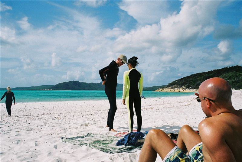 Sunbathing on Whitehaven Beach, whilst others prepare to brave the "stingers" and go for a swim.
