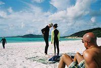 Sunbathing on Whitehaven Beach, whilst others prepare to brave the "stingers" and go for a swim.
